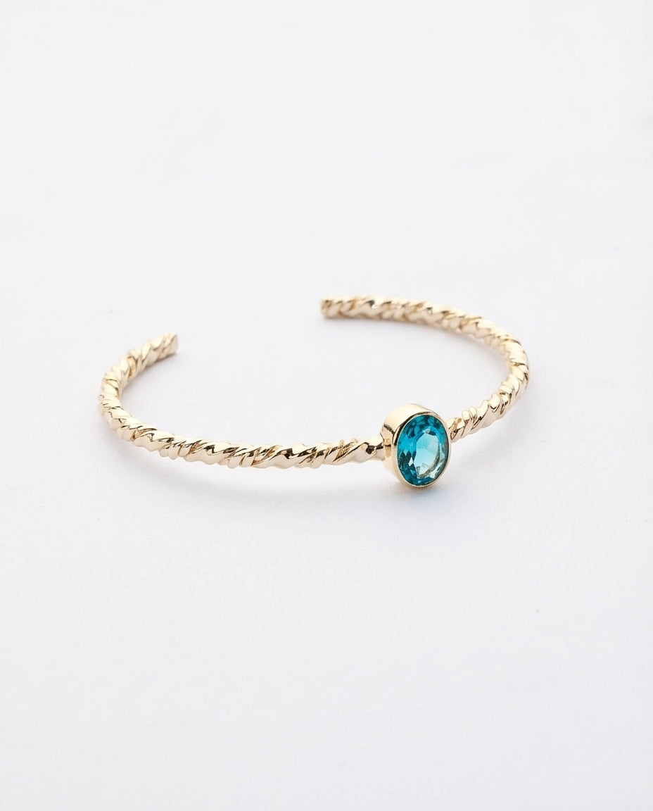 Twisted Gold Bangle with Oval Blue Topaz