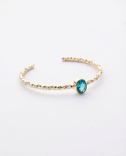 Twisted Gold Bangle with Oval Blue Topaz
