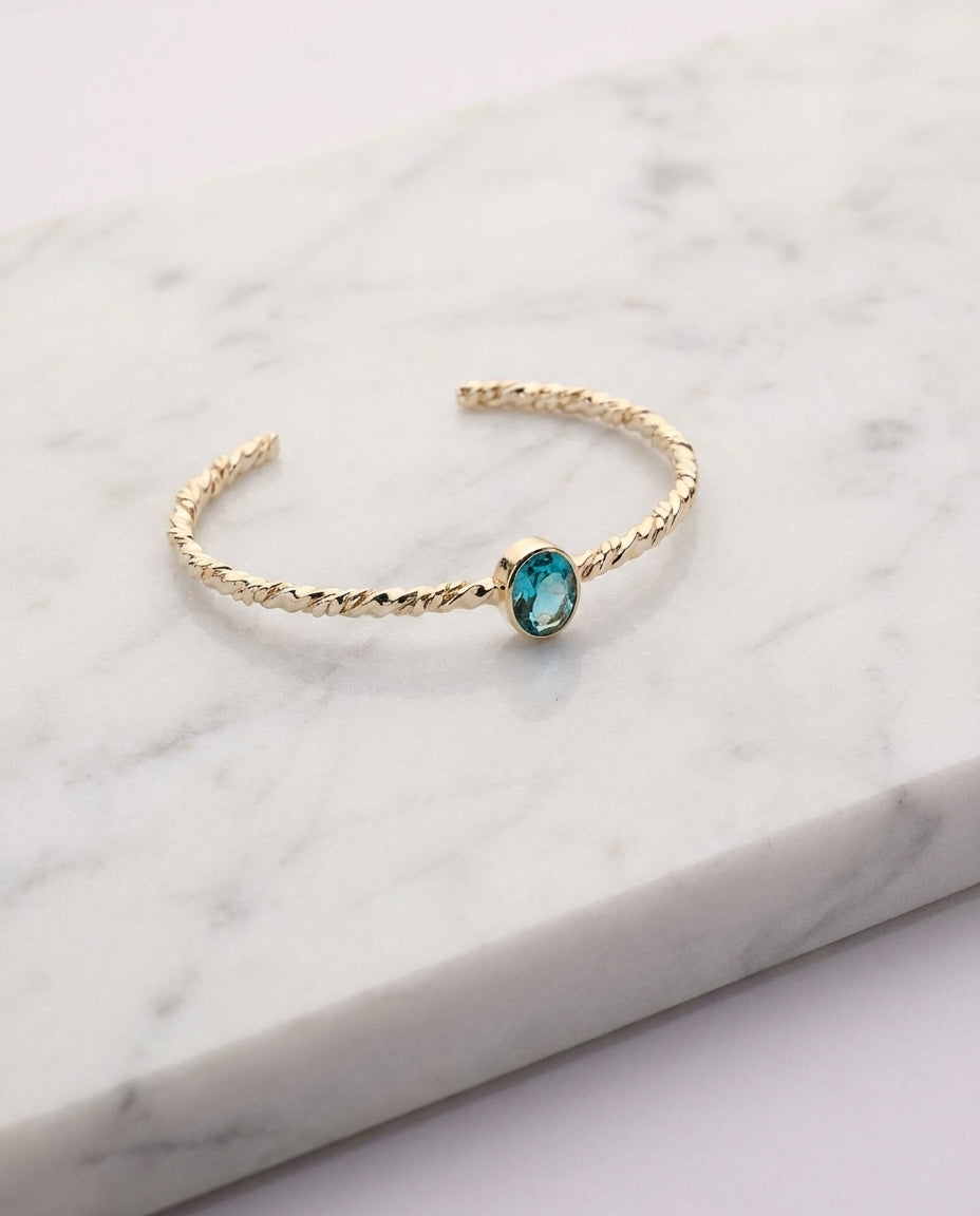 Twisted Gold Bangle with Oval Blue Topaz