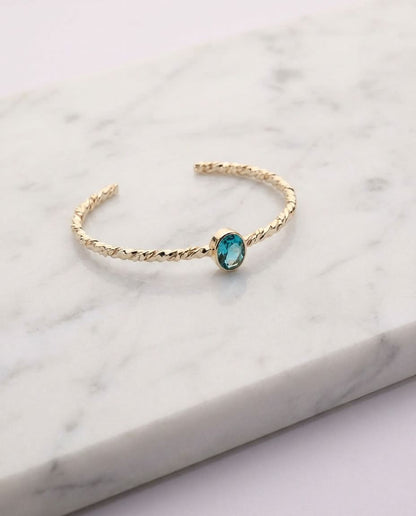 Twisted Gold Bangle with Oval Blue Topaz