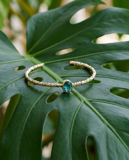 Twisted Gold Bangle with Oval Blue Topaz