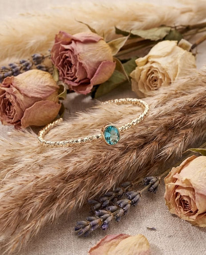 Twisted Gold Bangle with Oval Blue Topaz