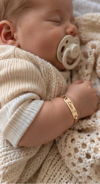 Sleeping baby wearing personalized gold bracelet