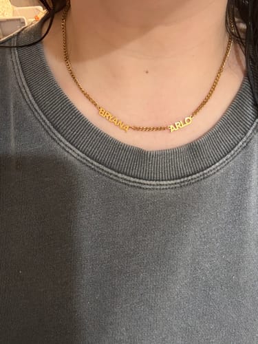 Customer wearing custom names from Jewelry Handcrafts