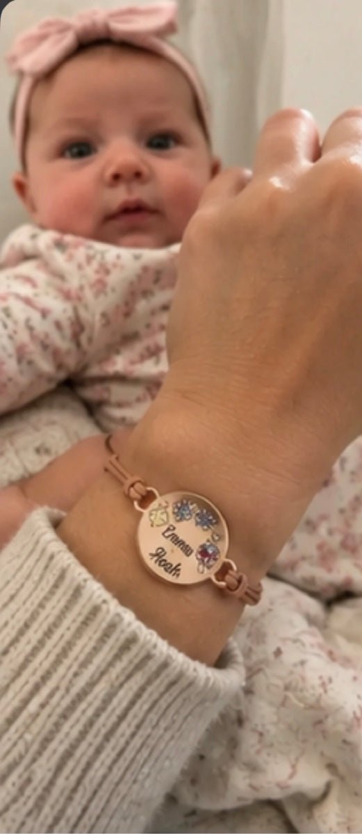 Mom wearing personalized kids birthstone bracelet with baby