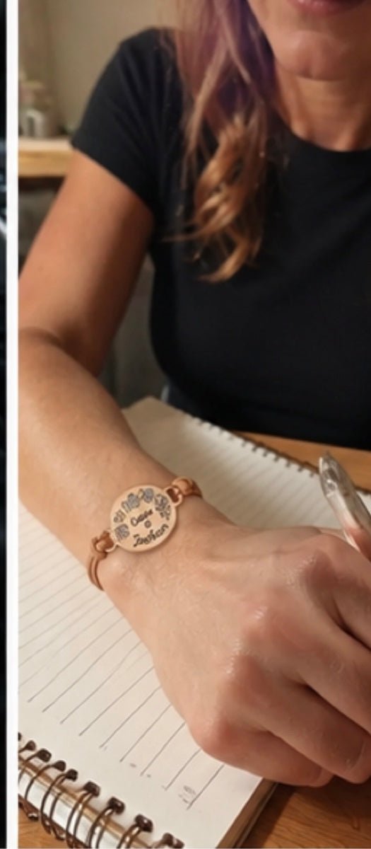 Mom wearing custom bracelet with kids names and birthstones while writing