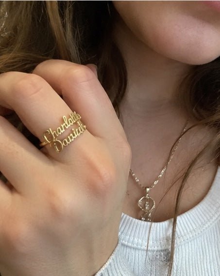 Customer wearing custom name ring near record player